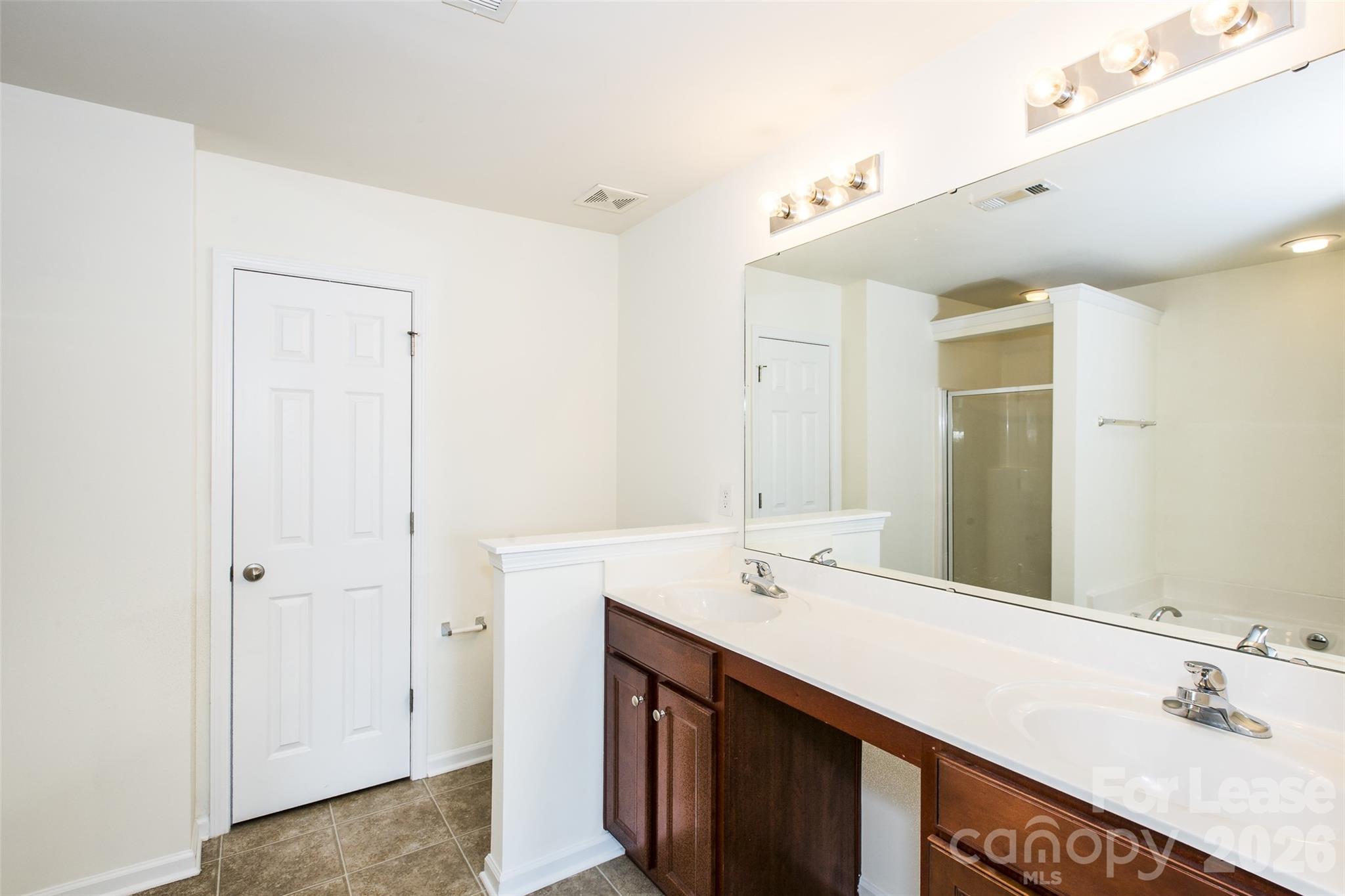 13422 Erwin Road Charlotte, NC 28273 - Photo 24 of 35 a bathroom with a sink double vanity and a mirror