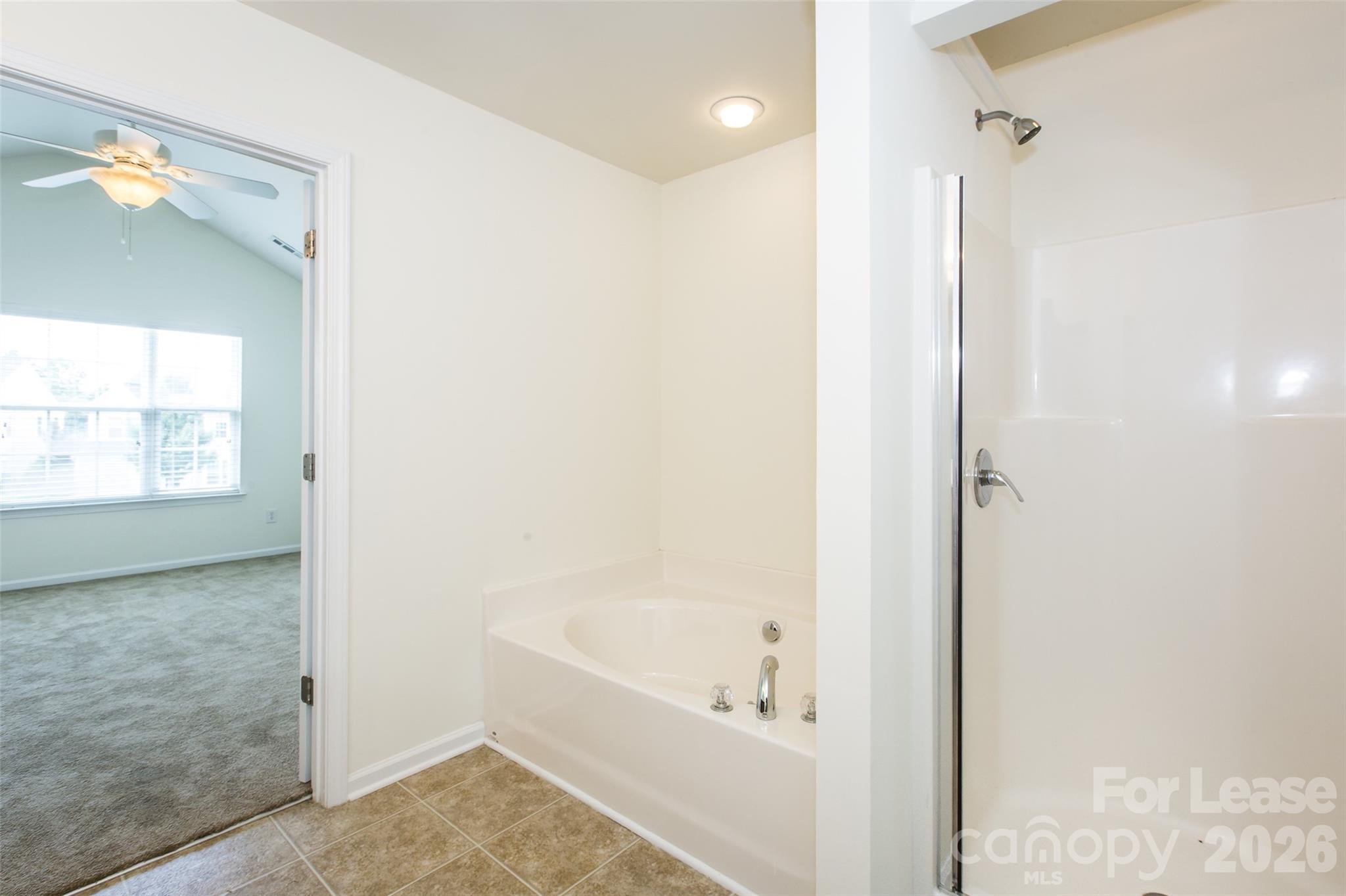 13422 Erwin Road Charlotte, NC 28273 - Photo 25 of 35 a bathroom with a bathtub and a shower