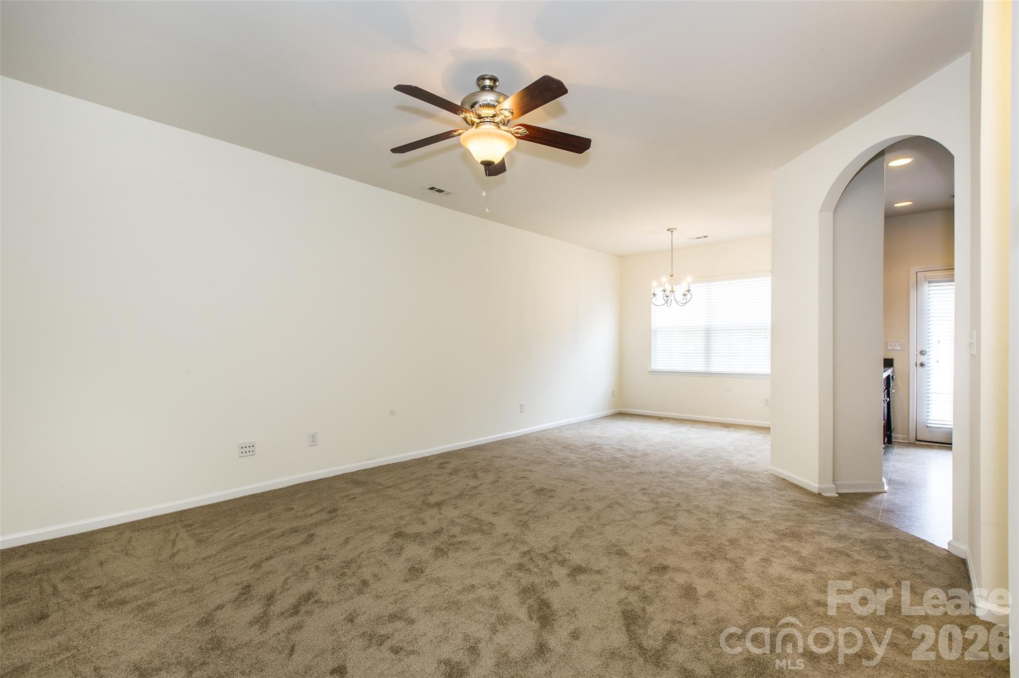 13422 Erwin Road Charlotte, NC 28273 - Photo 6 of 35 an empty room with windows and fan
