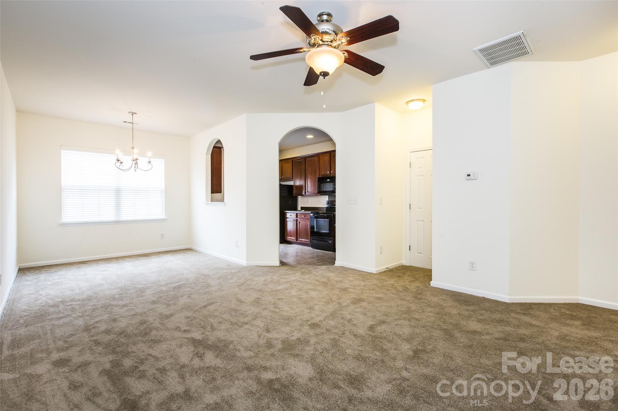 13422 Erwin Road Charlotte, NC 28273 - Photo 7 of 35 an empty room with a ceiling fan and a window