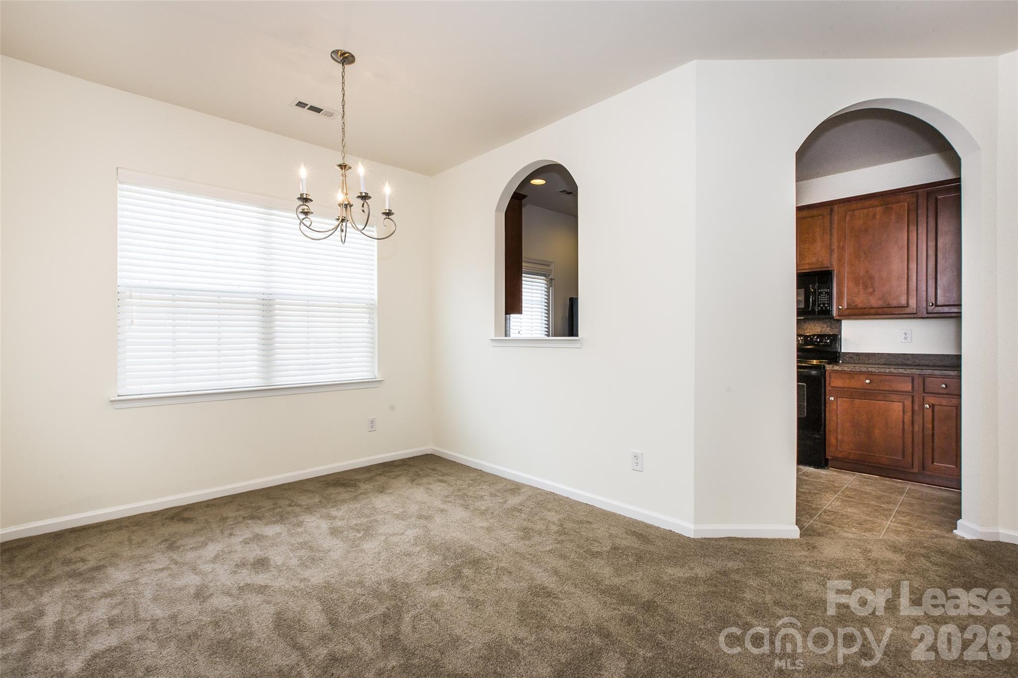 13422 Erwin Road Charlotte, NC 28273 - Photo 9 of 35 a view of a livingroom with a chandelier