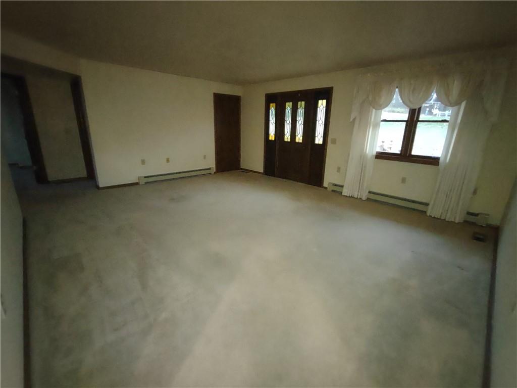 4641 Ellwood Road New Castle, PA 16101 - Photo 9 of 26 an empty room with chandelier fan and windows