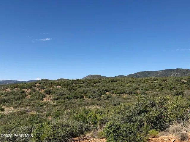 a view of a mountain range in a cloudy sky