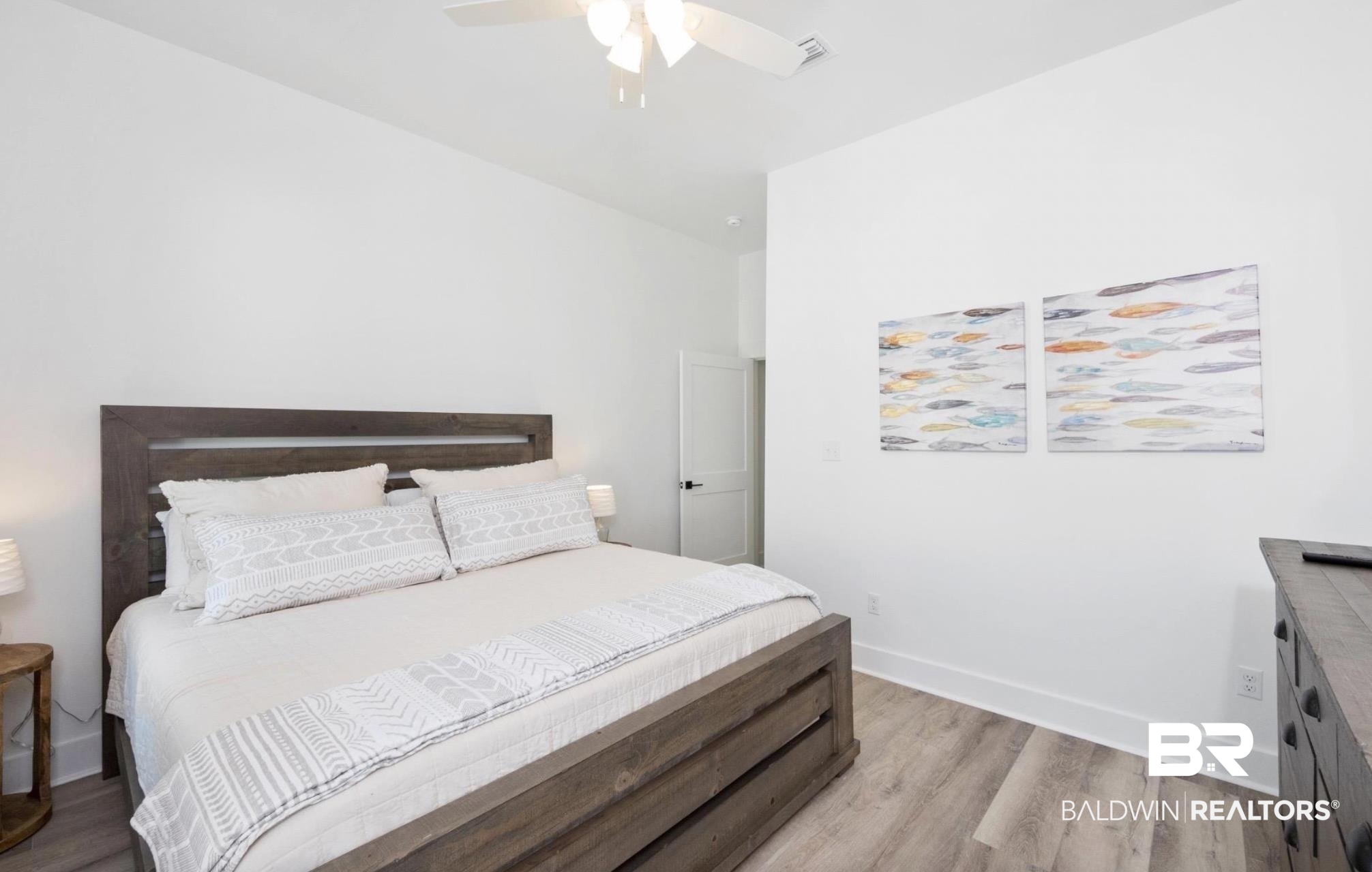 20 West Gate Orange Beach, AL 36561 - Photo 10 of 15 Bedroom featuring light wood-style floors and ceiling fan