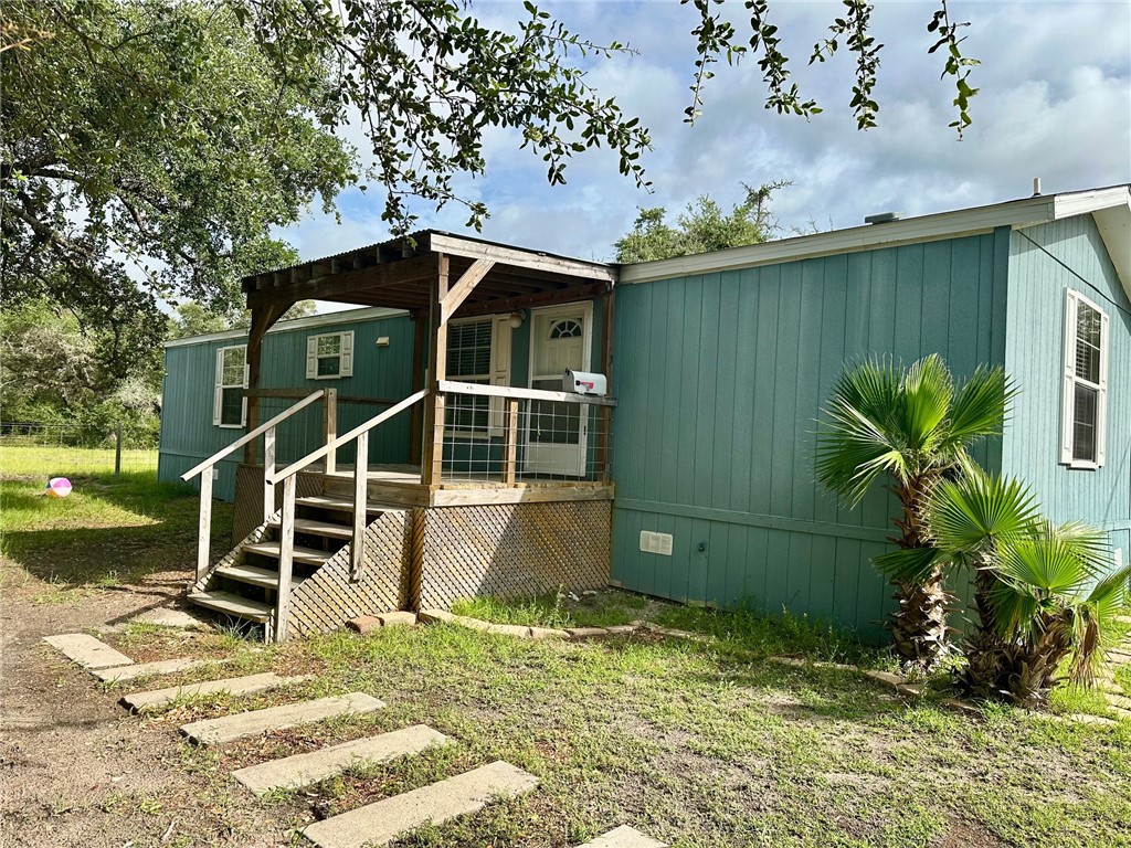 a backyard of a house with table and chairs