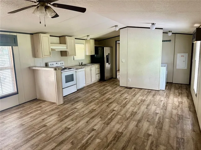 a kitchen with stainless steel appliances a refrigerator and a stove top oven