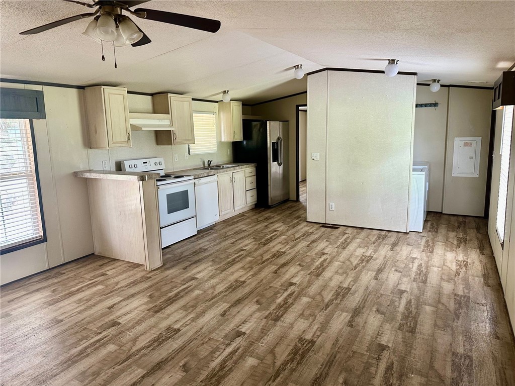 1522 16th Street, Unit 6 Rockport, TX 78382 - Photo 4 of 12 a kitchen with stainless steel appliances a refrigerator and a stove top oven