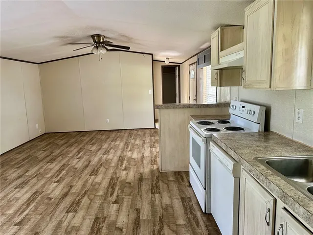 a kitchen with a stove a sink and a refrigerator