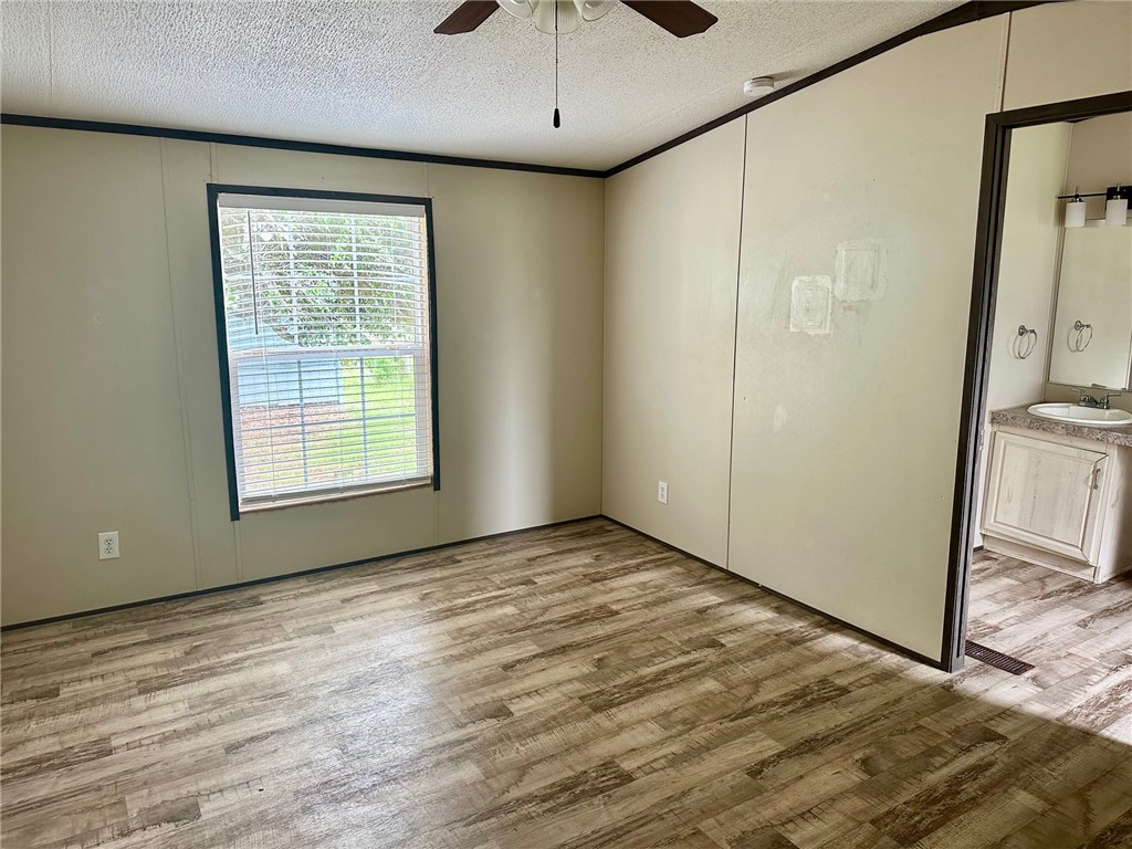 1522 16th Street, Unit 6 Rockport, TX 78382 - Photo 8 of 12 a view of an empty room with window and wooden floor