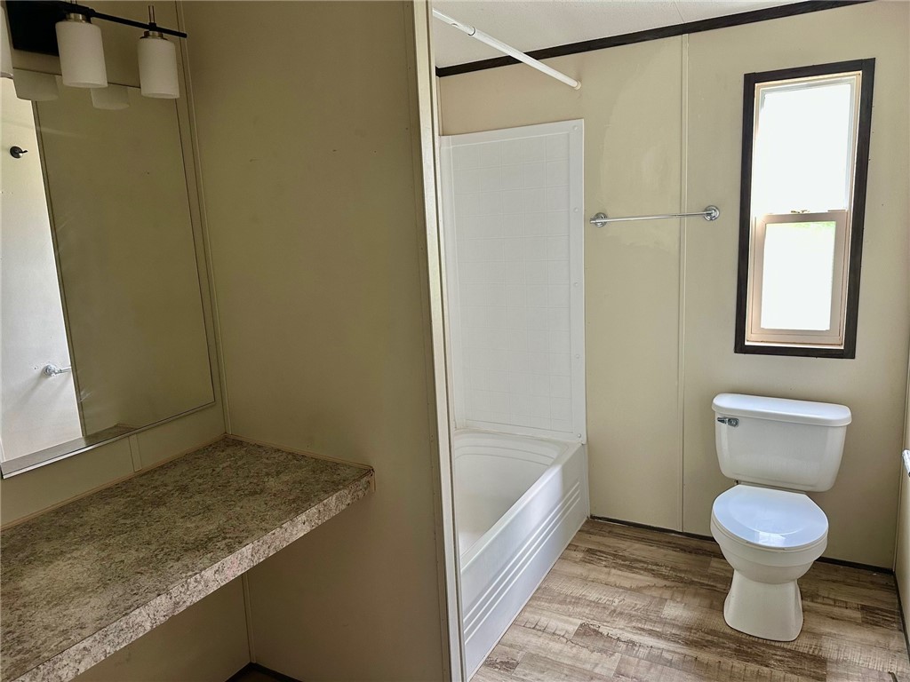 1522 16th Street, Unit 6 Rockport, TX 78382 - Photo 9 of 12 a bathroom with a toilet and a shower