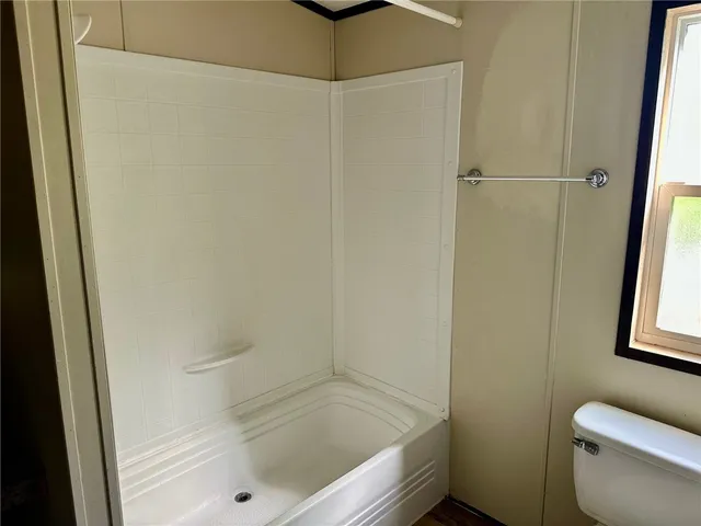 a bathroom with a bathtub and a toilet