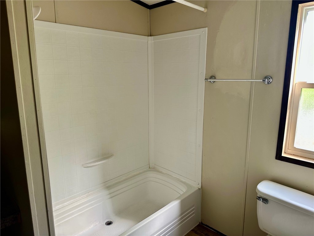 1522 16th Street, Unit 6 Rockport, TX 78382 - Photo 10 of 12 a bathroom with a bathtub and a toilet