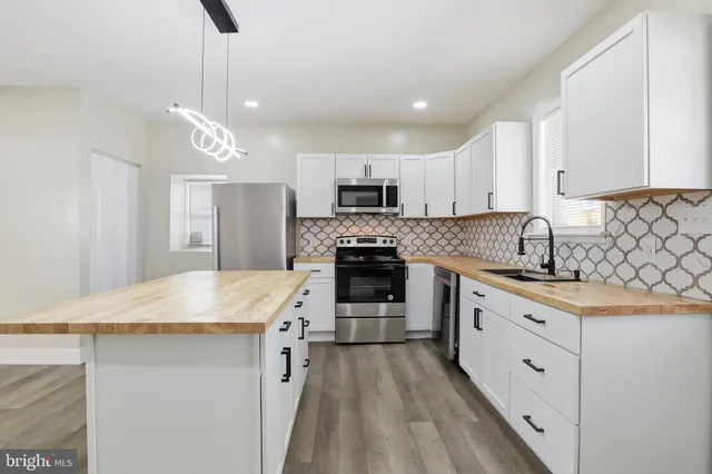 a kitchen with a sink and a mirror