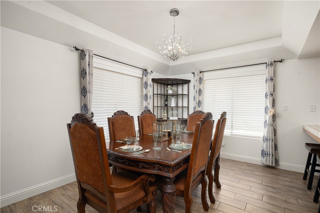2119 Jenkins Road Bakersfield, CA 93314 - Photo 13 of 35 a view of a dining room with furniture window and wooden floor
