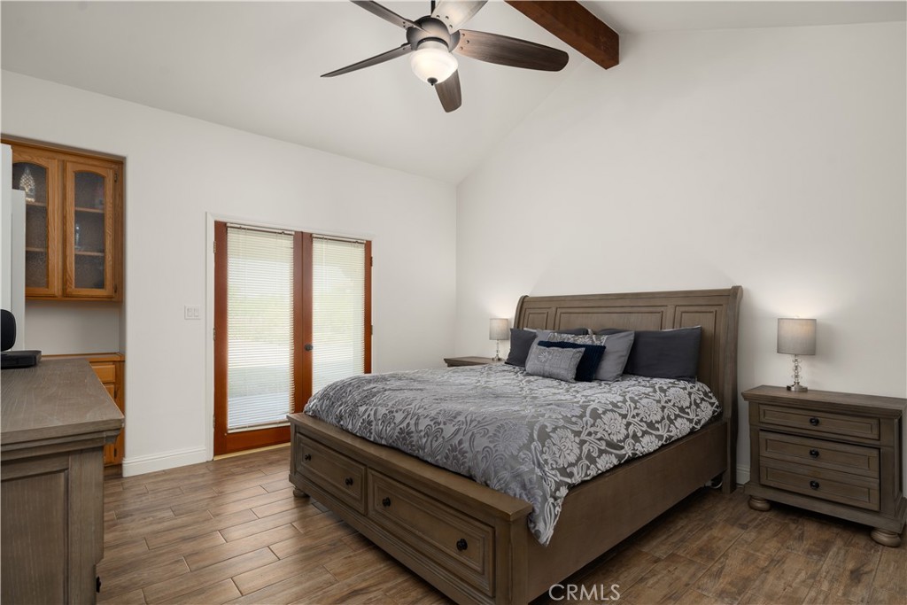 2119 Jenkins Road Bakersfield, CA 93314 - Photo 22 of 35 a bedroom with a bed and wooden floor