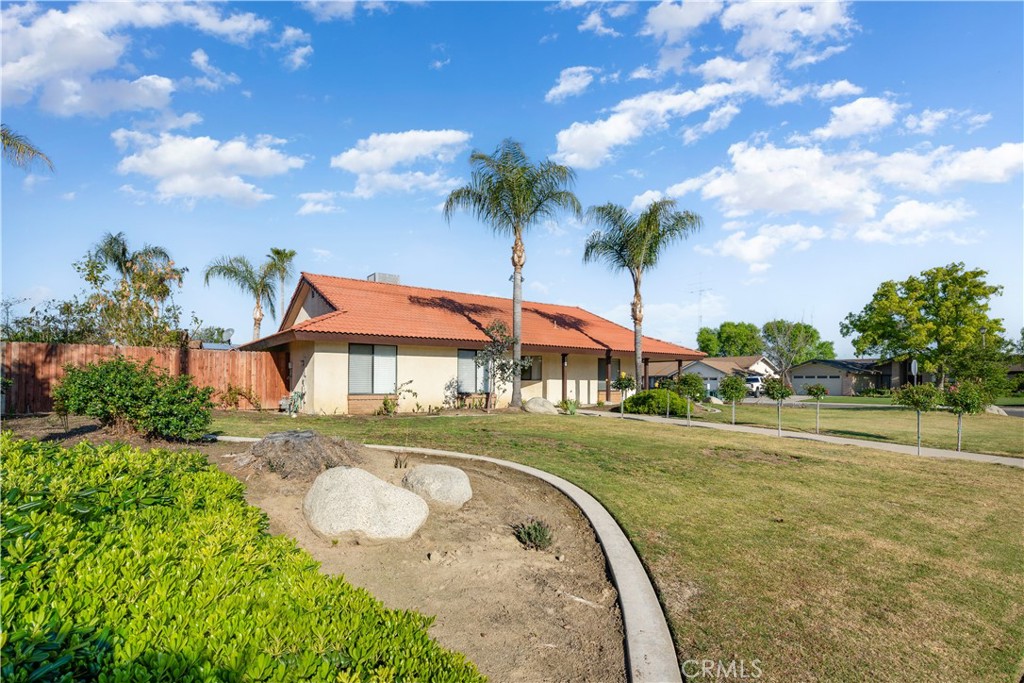 2119 Jenkins Road Bakersfield, CA 93314 - Photo 31 of 35 a view of a house with a yard and a garden