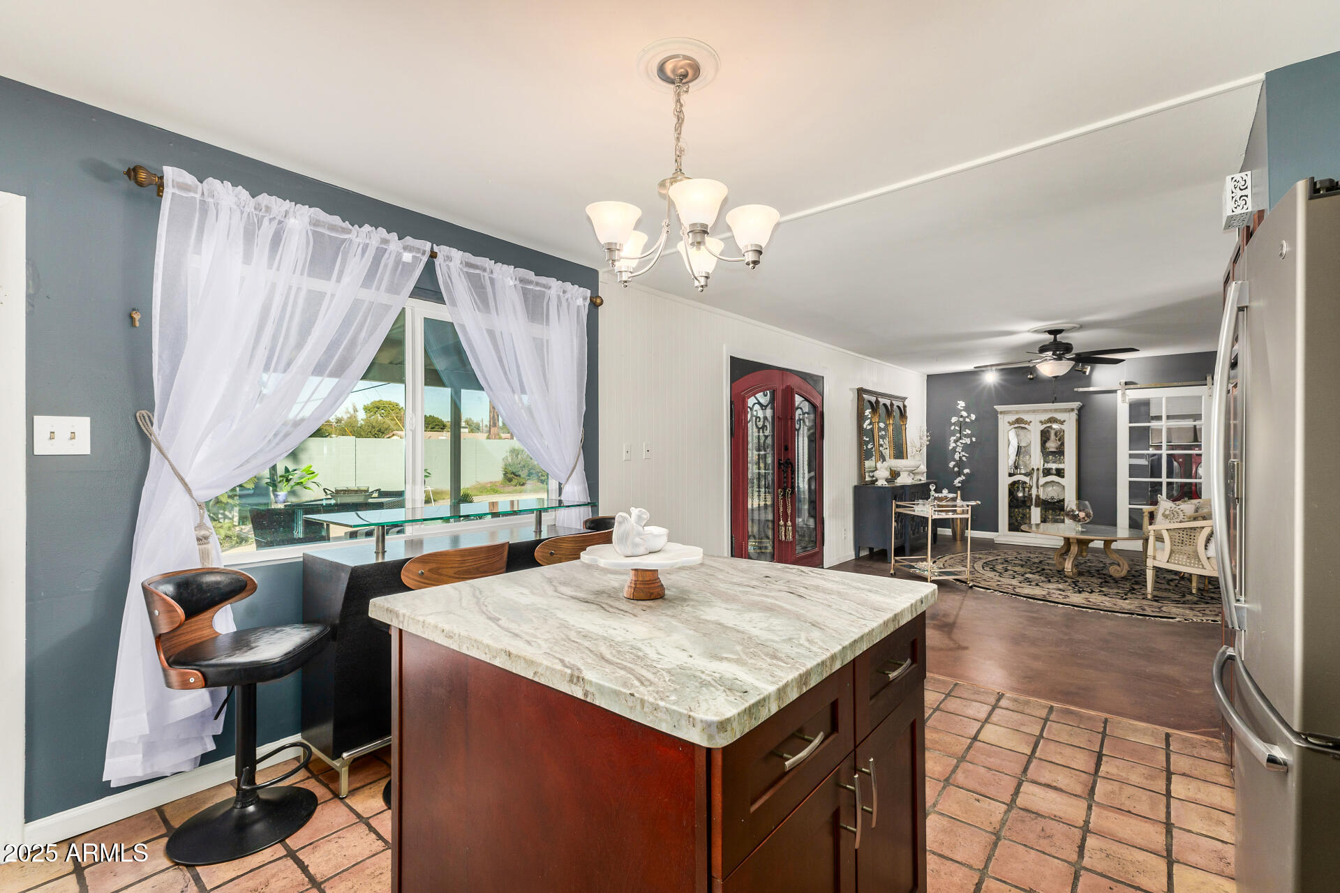 a kitchen with a table chairs and a chandelier