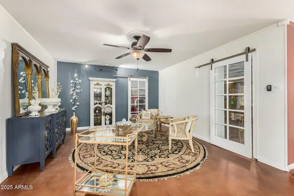 a living room with furniture and a chandelier