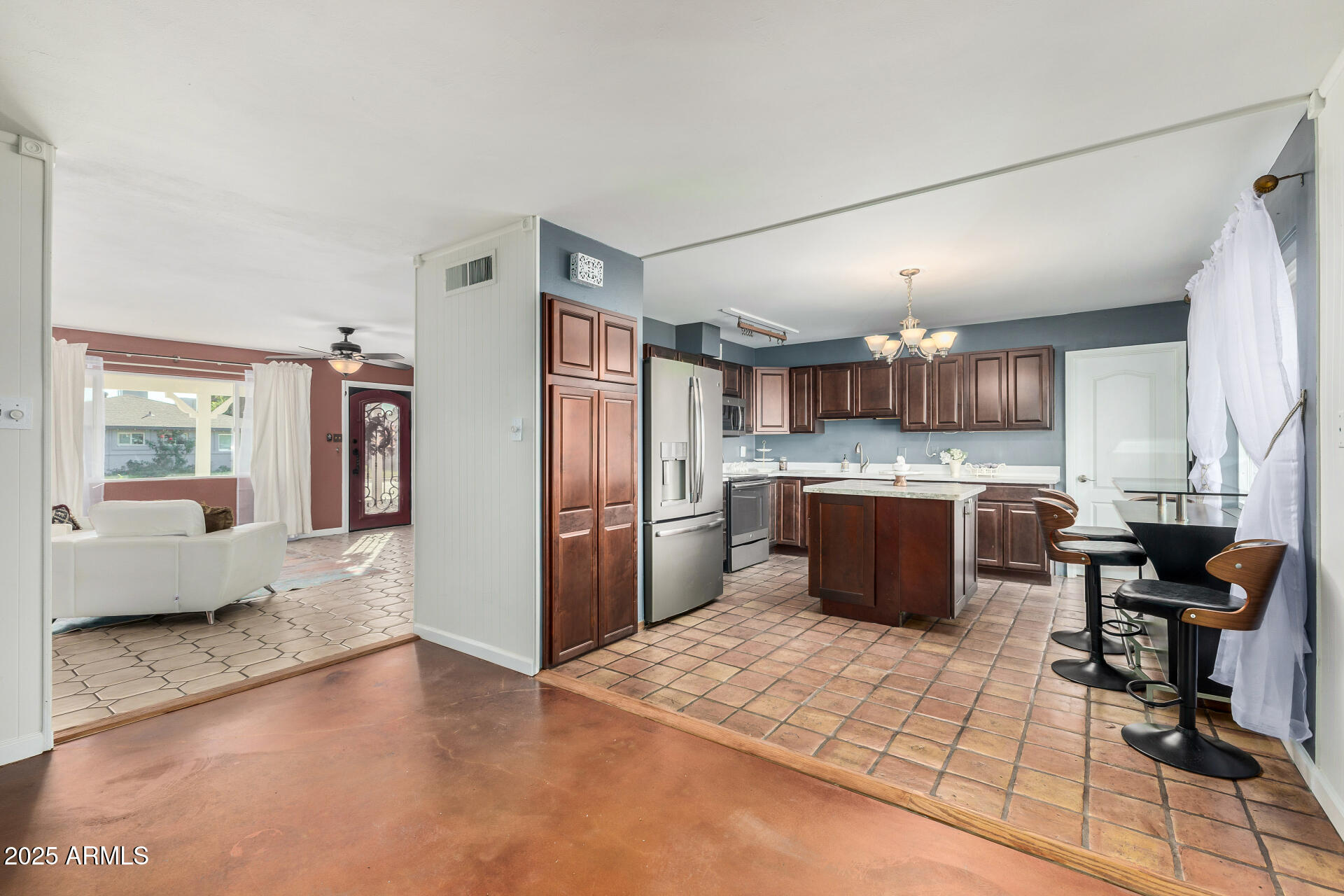 2302 West Berridge Lane Phoenix, AZ 85015 - Photo 13 of 40 a kitchen with stainless steel appliances kitchen island granite countertop a refrigerator and a sink