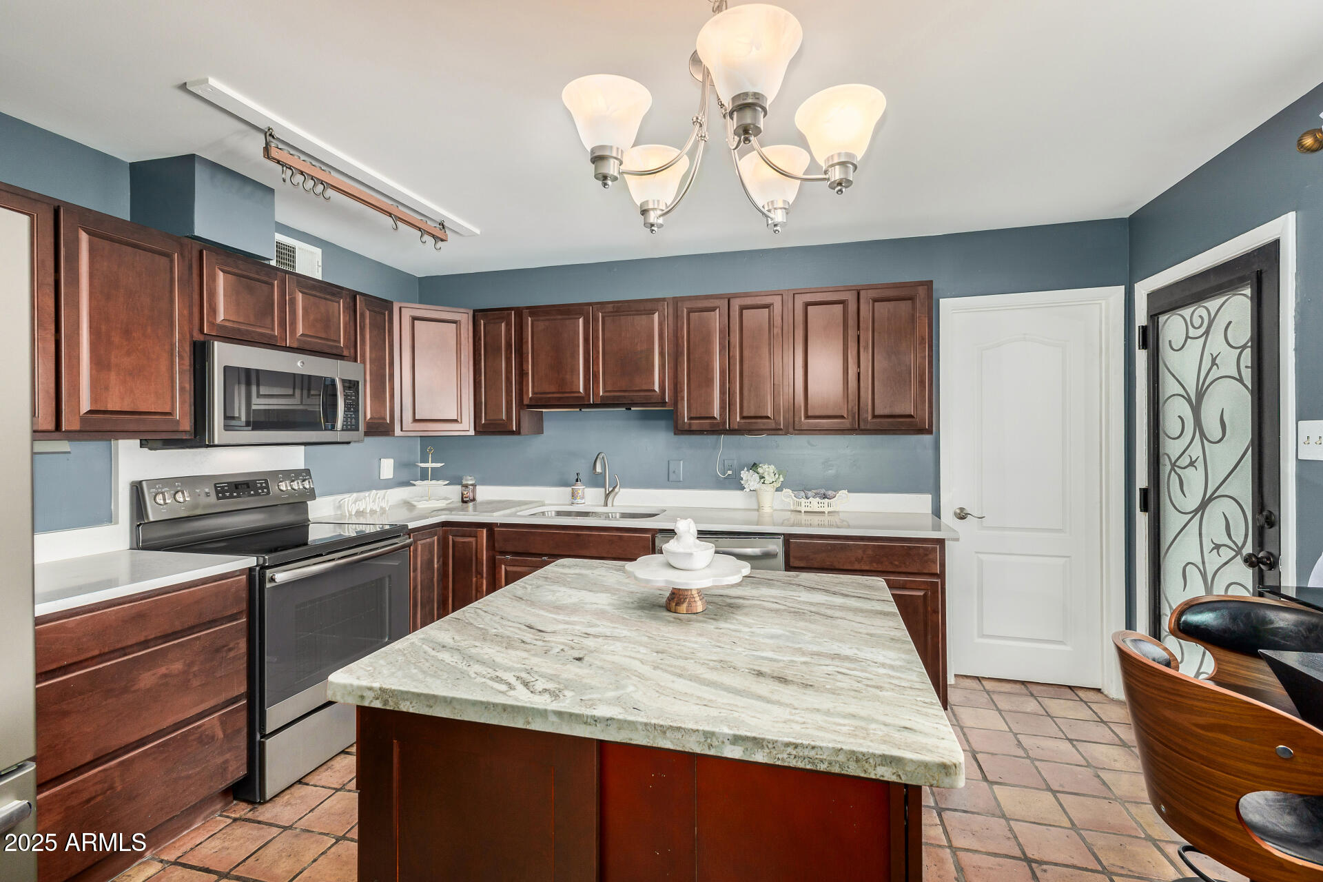 2302 West Berridge Lane Phoenix, AZ 85015 - Photo 15 of 40 a kitchen with a stove a sink a microwave a refrigerator cabinets and dining table