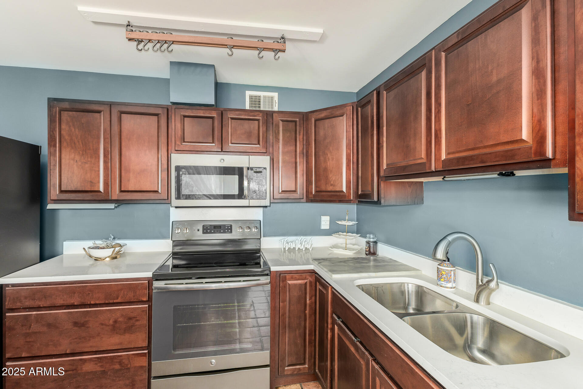 2302 West Berridge Lane Phoenix, AZ 85015 - Photo 16 of 40 a kitchen with stainless steel appliances granite countertop a sink stove and refrigerator
