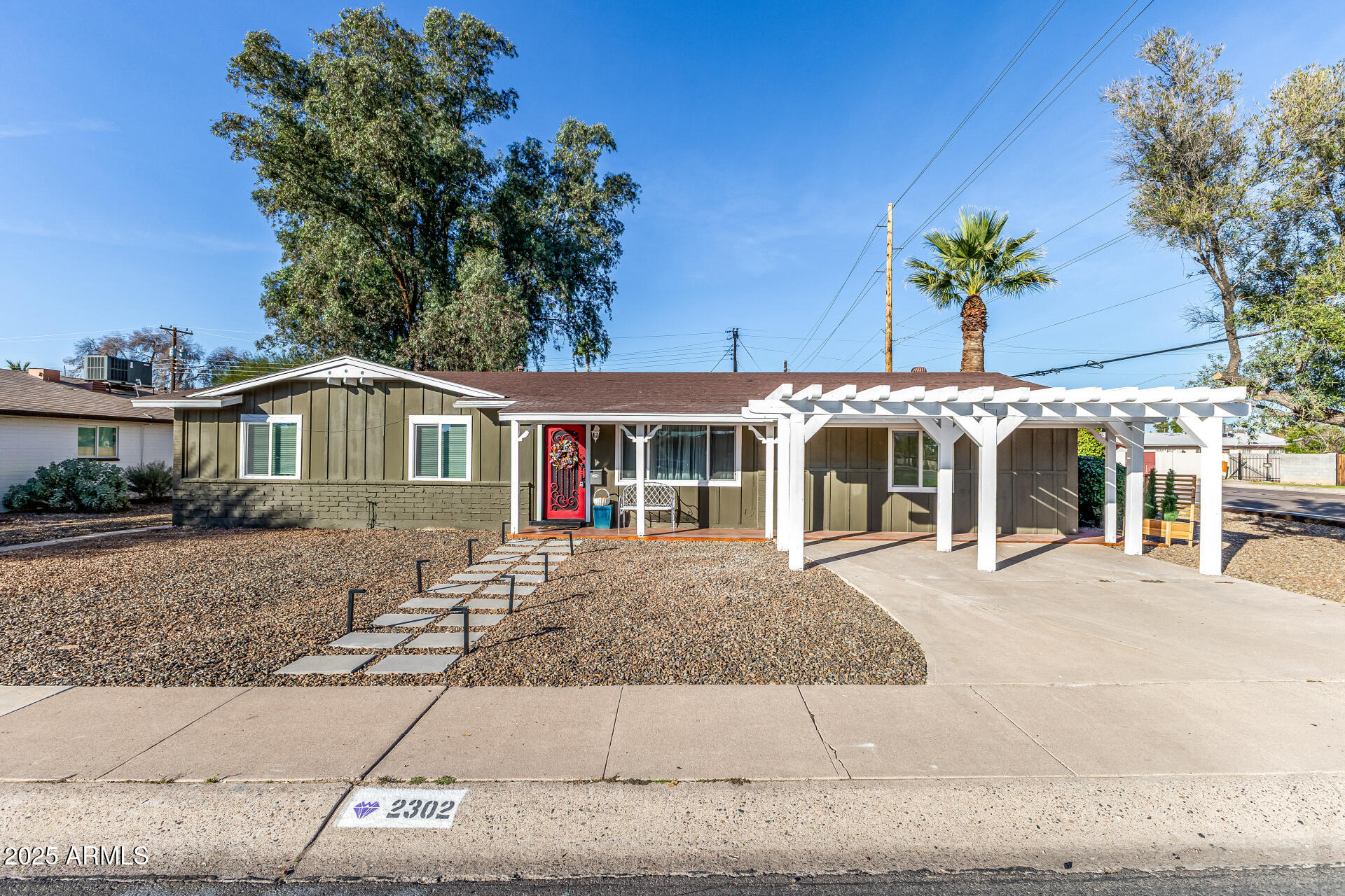 2302 West Berridge Lane Phoenix, AZ 85015 - Photo 2 of 40 a front view of a house with garden