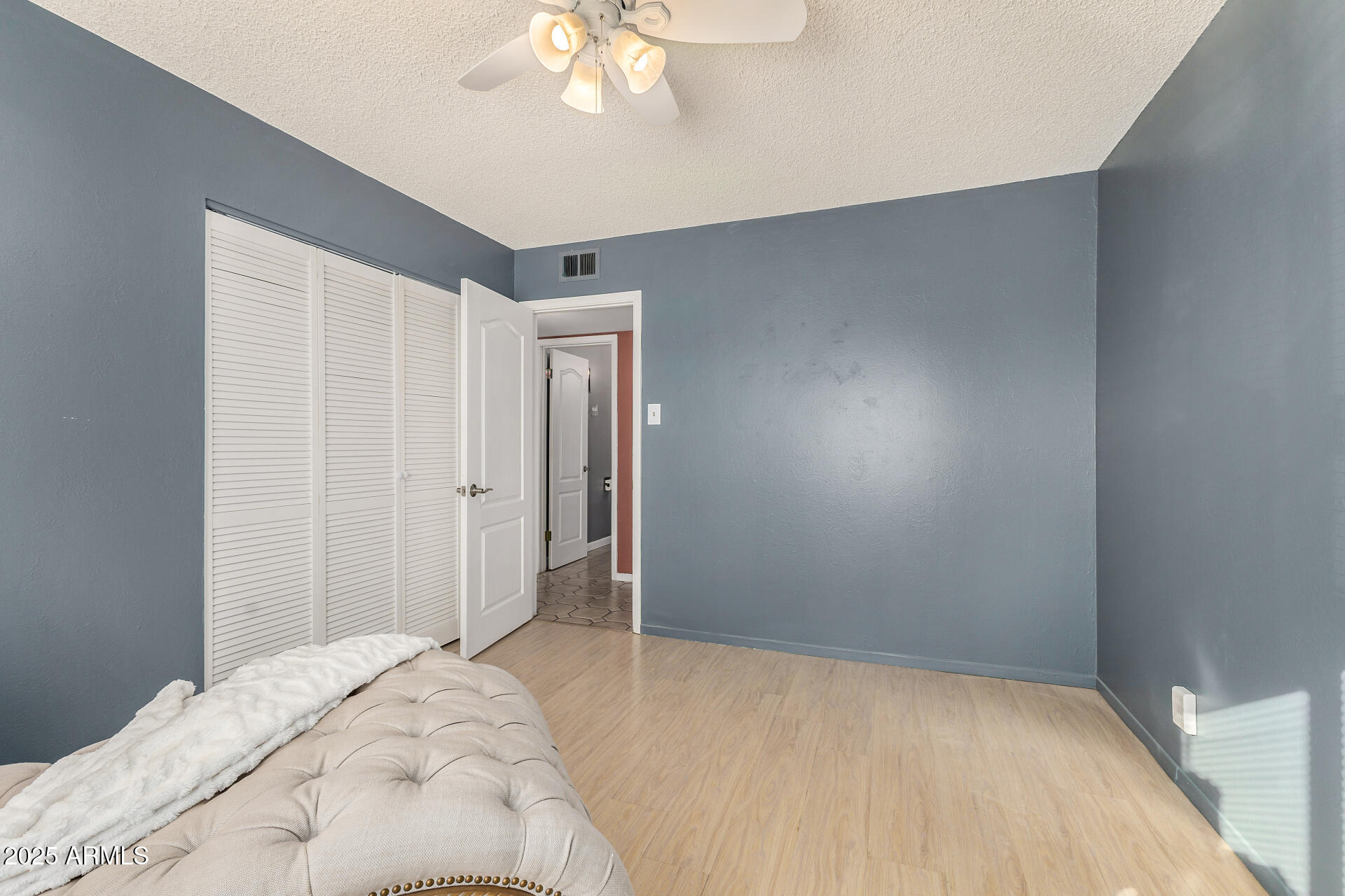 2302 West Berridge Lane Phoenix, AZ 85015 - Photo 25 of 40 a bedroom with a bed and a chandelier fan