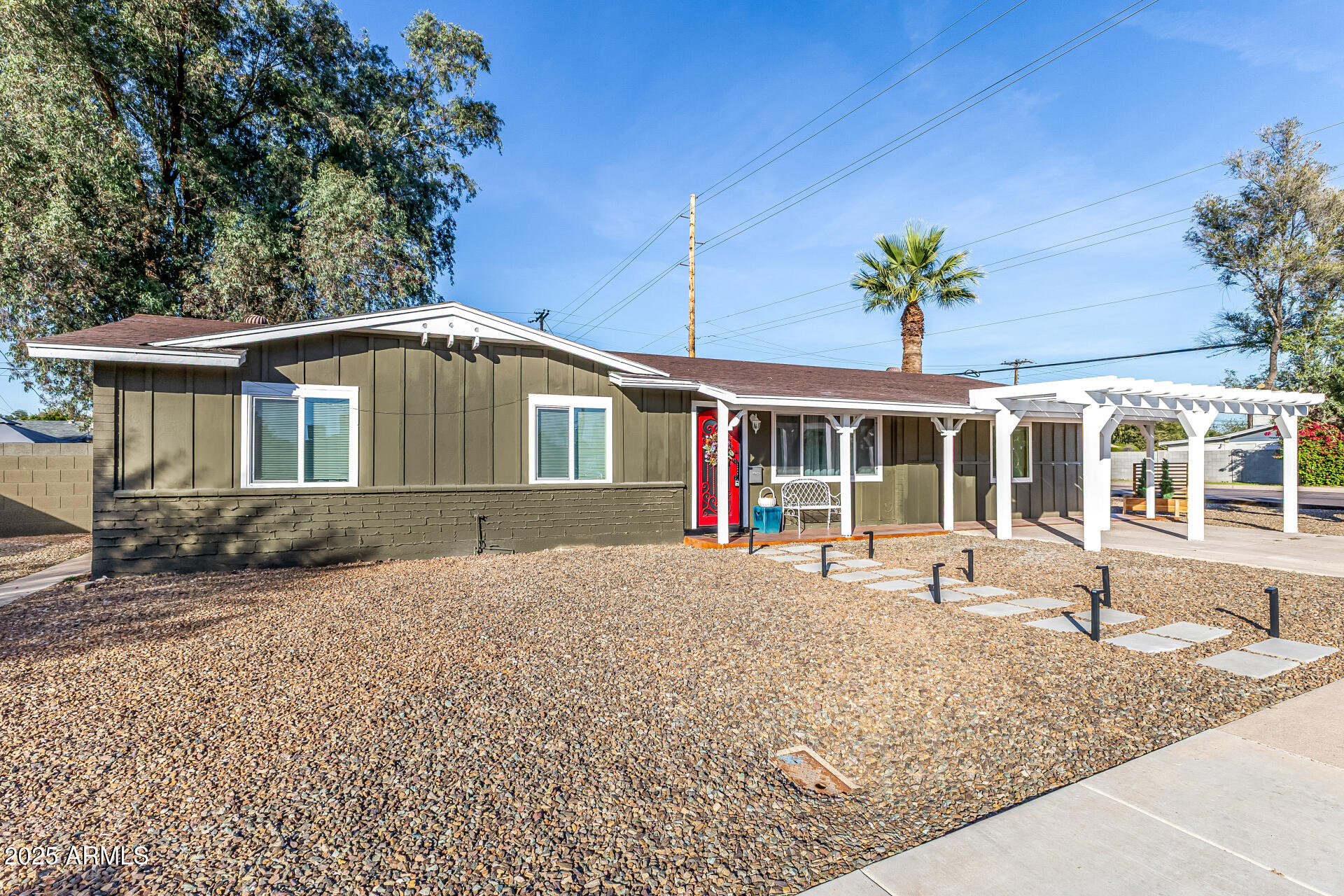 2302 West Berridge Lane Phoenix, AZ 85015 - Photo 4 of 40 a front view of a house with a garden and patio