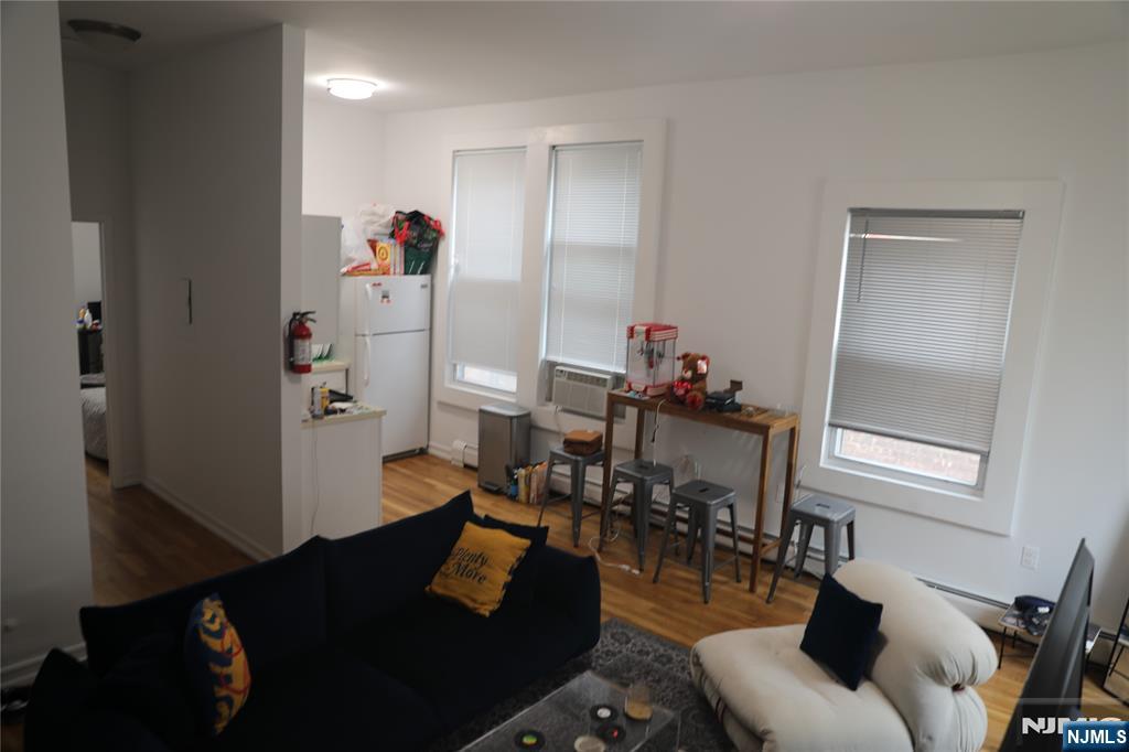 41 Glenridge Avenue, Unit 2L Montclair, NJ 07042 - Photo 4 of 6 a living room with furniture and wooden floor