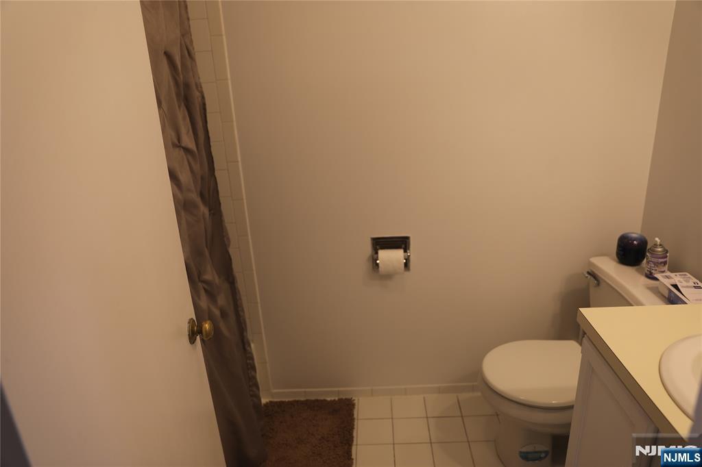 41 Glenridge Avenue, Unit 2L Montclair, NJ 07042 - Photo 5 of 6 a white toilet sitting next to a small bathroom