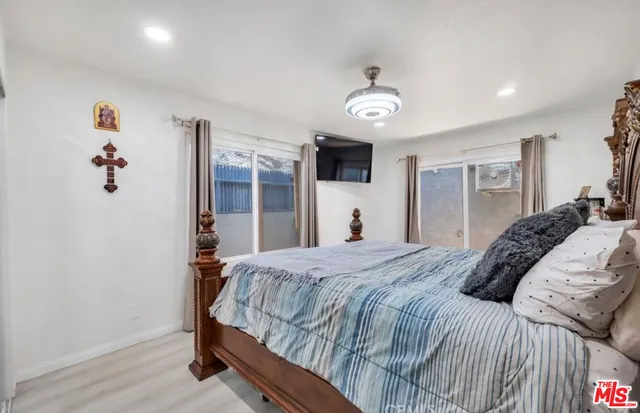 a bedroom with a large bed and a chandelier