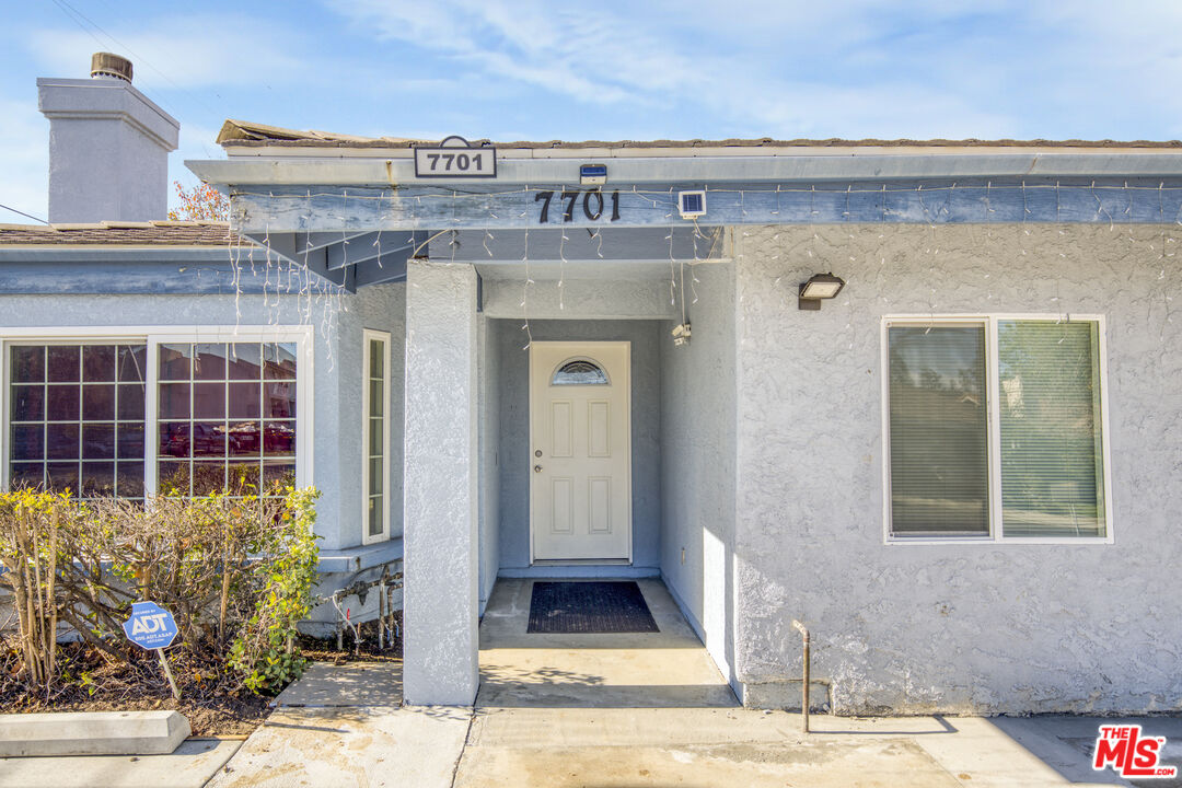7701 Baird Avenue Reseda, CA 91335 - Photo 15 of 21 a front view of a building with potted plants