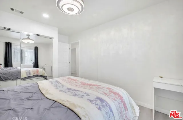 a bedroom with a bed and a couch