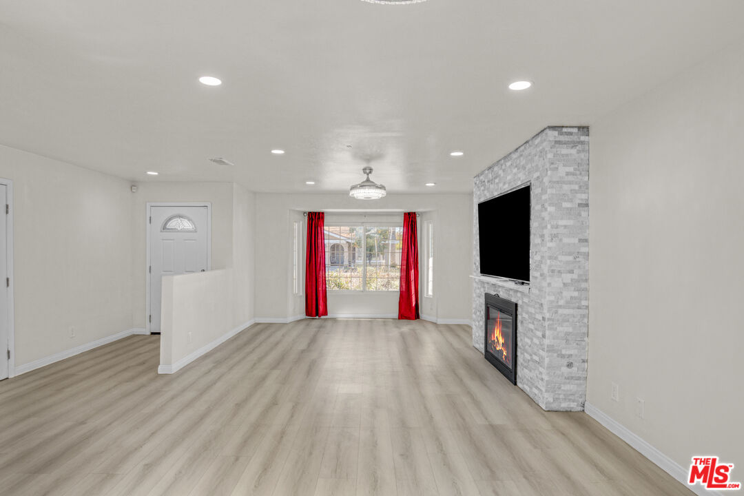 7701 Baird Avenue Reseda, CA 91335 - Photo 2 of 21 a living room with furniture and a flat screen tv