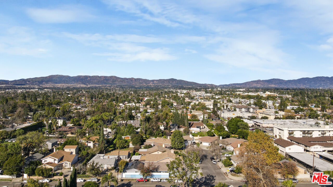 7701 Baird Avenue Reseda, CA 91335 - Photo 21 of 21 an aerial view of residential house with parking and mountain view in back