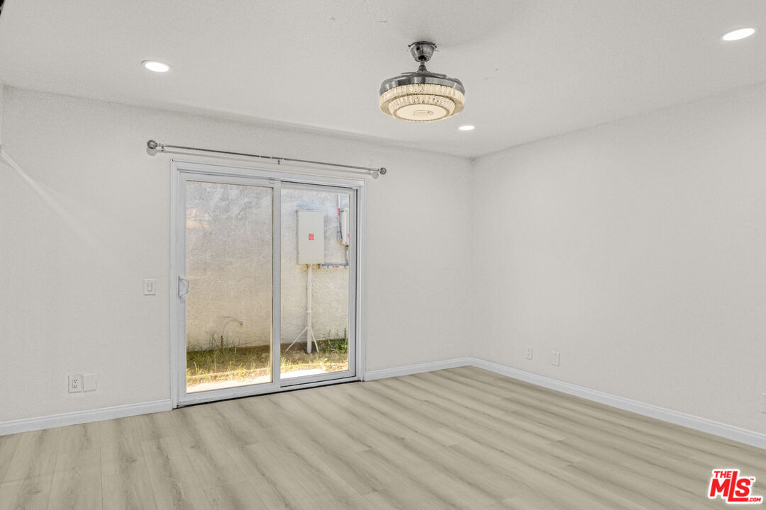 7701 Baird Avenue Reseda, CA 91335 - Photo 9 of 21 a view of an empty room with wooden floor