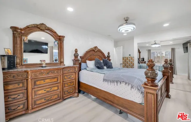 a bed room with a bed and a mirror