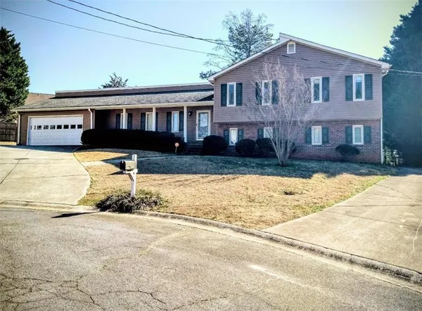 a front view of a house with a yard covered in snow