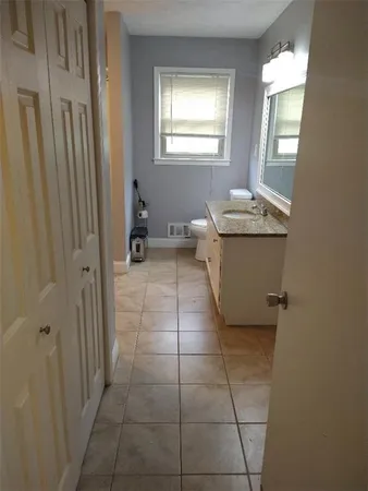 a bathroom with a sink a toilet and mirror