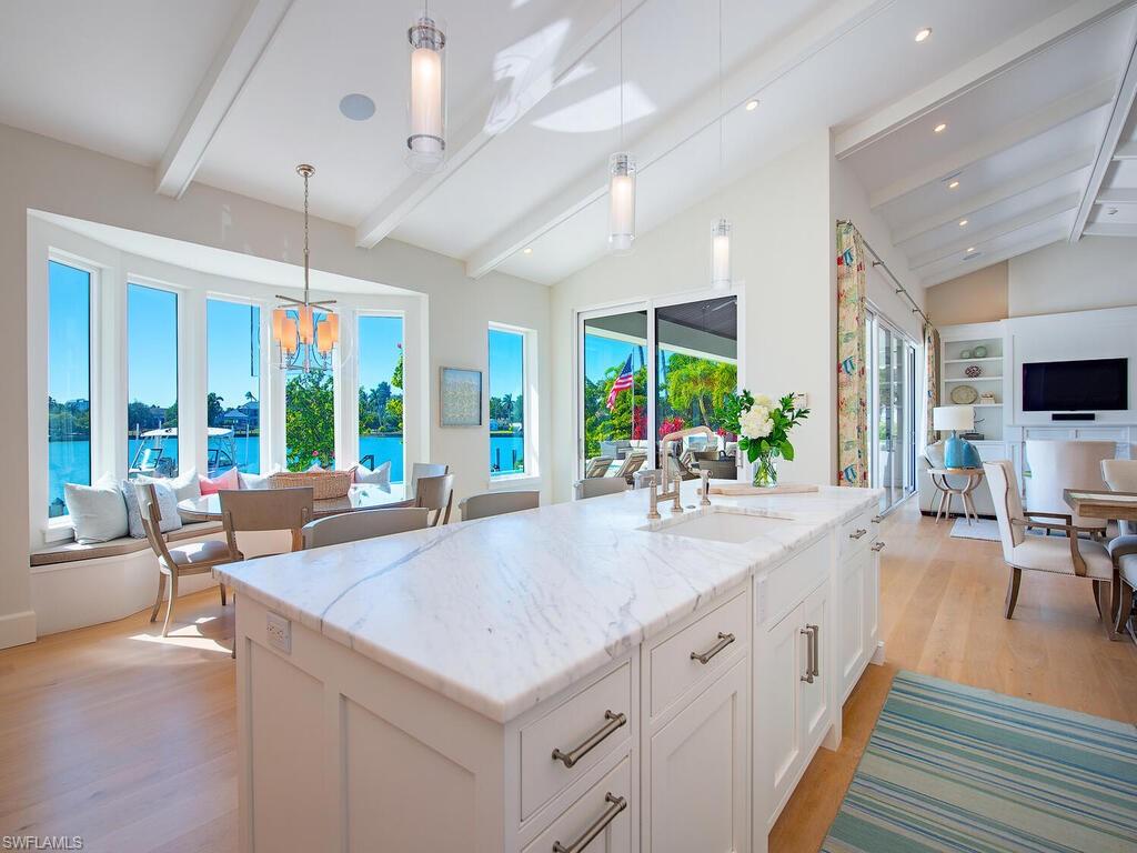 440 Springline Drive Naples, FL 34102 - Photo 12 of 28 a large kitchen with kitchen island a large window in it
