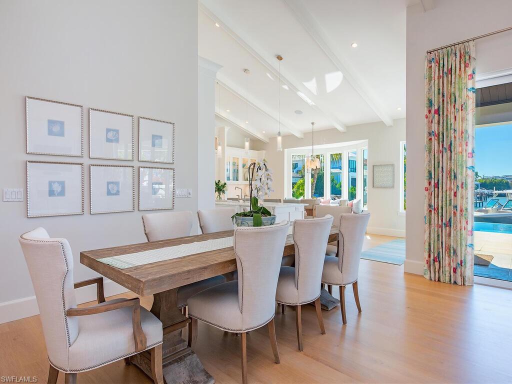 440 Springline Drive Naples, FL 34102 - Photo 14 of 28 a view of a dining room with furniture and wooden floor