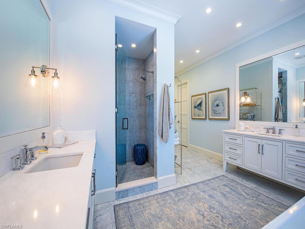 440 Springline Drive Naples, FL 34102 - Photo 18 of 28 a bathroom with a granite countertop sink mirror and bathtub