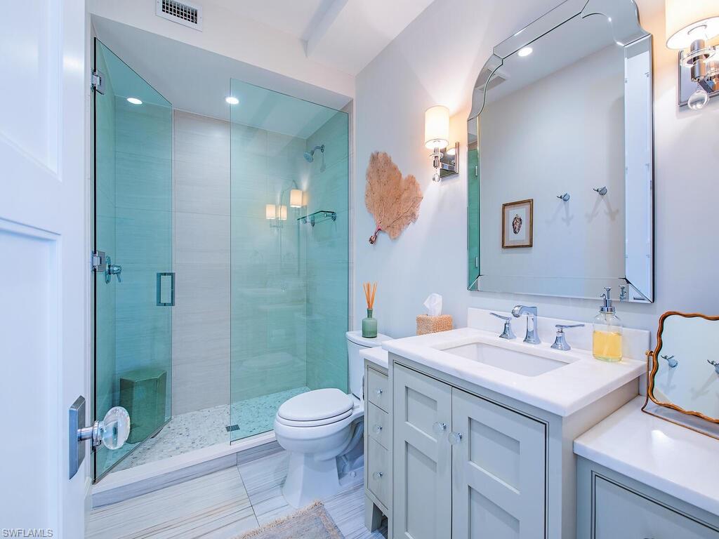 440 Springline Drive Naples, FL 34102 - Photo 26 of 28 a bathroom with a sink a toilet and shower