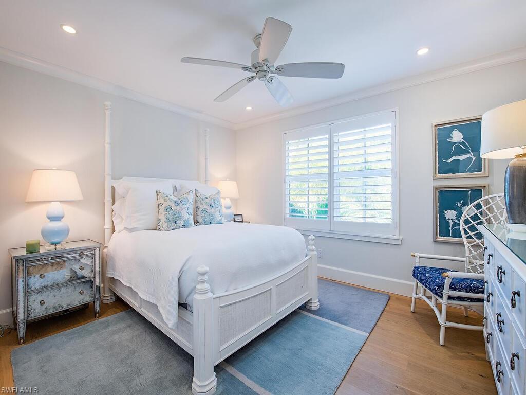 440 Springline Drive Naples, FL 34102 - Photo 27 of 28 a bedroom with a bed wooden floor and a window