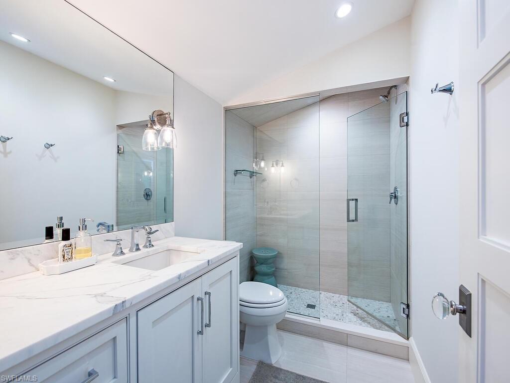440 Springline Drive Naples, FL 34102 - Photo 28 of 28 a bathroom with a granite countertop sink a toilet and shower