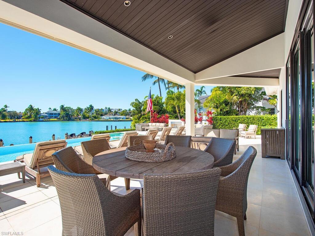 440 Springline Drive Naples, FL 34102 - Photo 5 of 28 a outdoor dining space with furniture and garden view