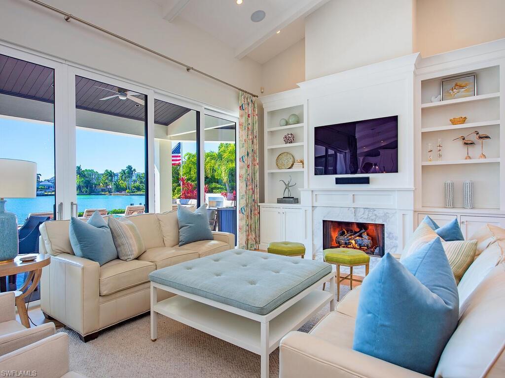 440 Springline Drive Naples, FL 34102 - Photo 7 of 28 a living room with fireplace furniture and a flat screen tv
