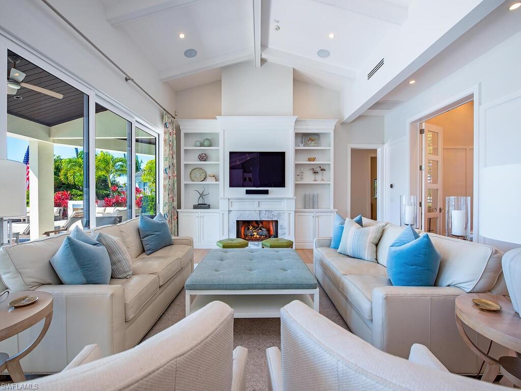 440 Springline Drive Naples, FL 34102 - Photo 8 of 28 a living room with fireplace furniture and a flat screen tv