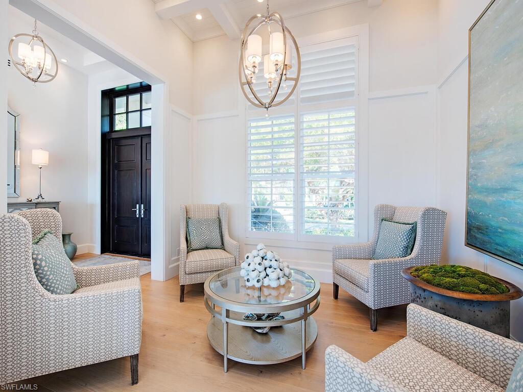 440 Springline Drive Naples, FL 34102 - Photo 9 of 28 a living room with furniture and a large window