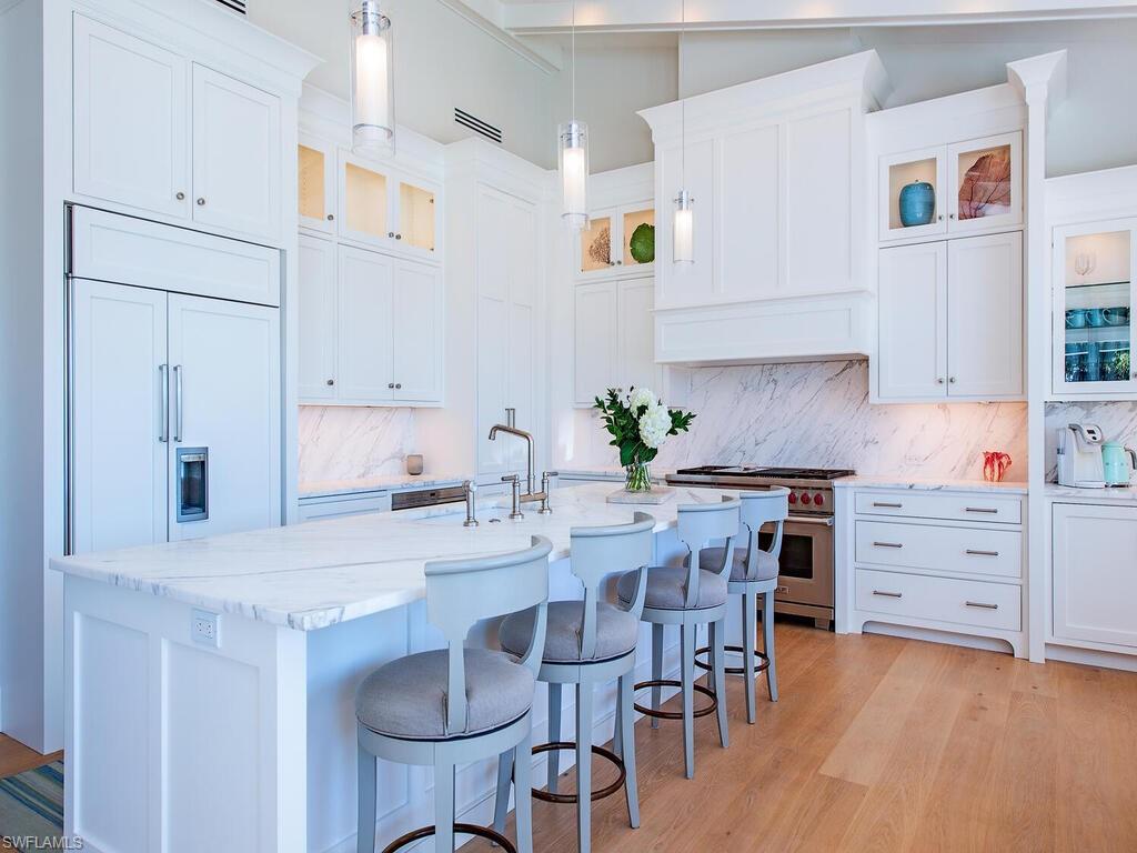 440 Springline Drive Naples, FL 34102 - Photo 10 of 28 a kitchen with granite countertop a sink cabinets and wooden floor